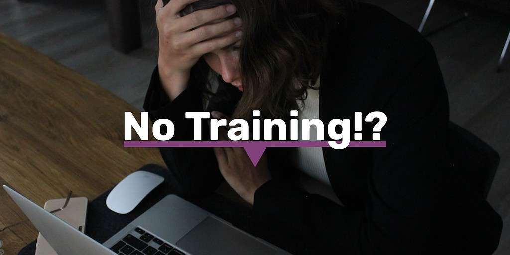 A woman sitting over her laptop with her hand on her forehead looking stressed out.